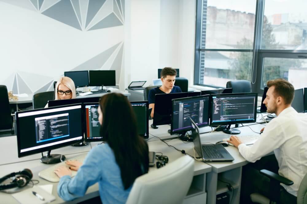 Team of software engineers coding and innovating at a top Custom Software Development Company Houston